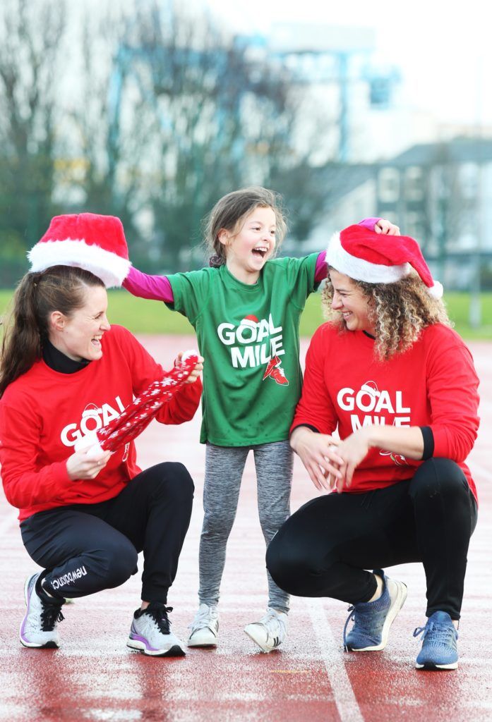 NO REPRO FEE 12/12/2019  Little Saoirse Moore 7yrs puts hats on GOAL ambassadors, Rugby international, Jenny Murphy and middle distance running champion, Ciara Mageean at the  launch the of this years GOAL mile in the iconic Irishtown Stadium in Dublin. Now in its 38th year, the GOAL Mile is one of Ireland’s largest and longest-running annual fundraising events and organisers revealed today that they are expecting  a record number of people to take part this year. All GOAL Miles are listed at goalmile.org with dates and times.Photo: Leon Farrell/Photocall Ireland.