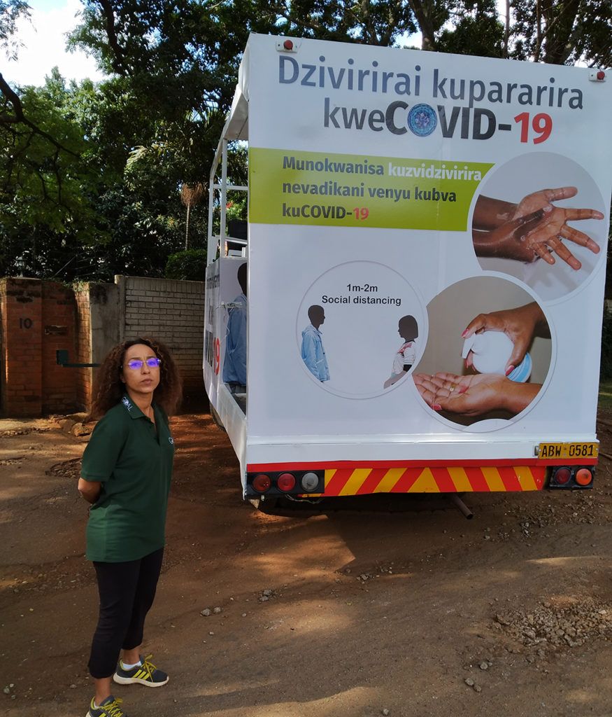 GOAL Zimbabwe's Country Director Gabriella Prandini stands with loudspeaker truck to be used in national COVID-19 messaging campaign
