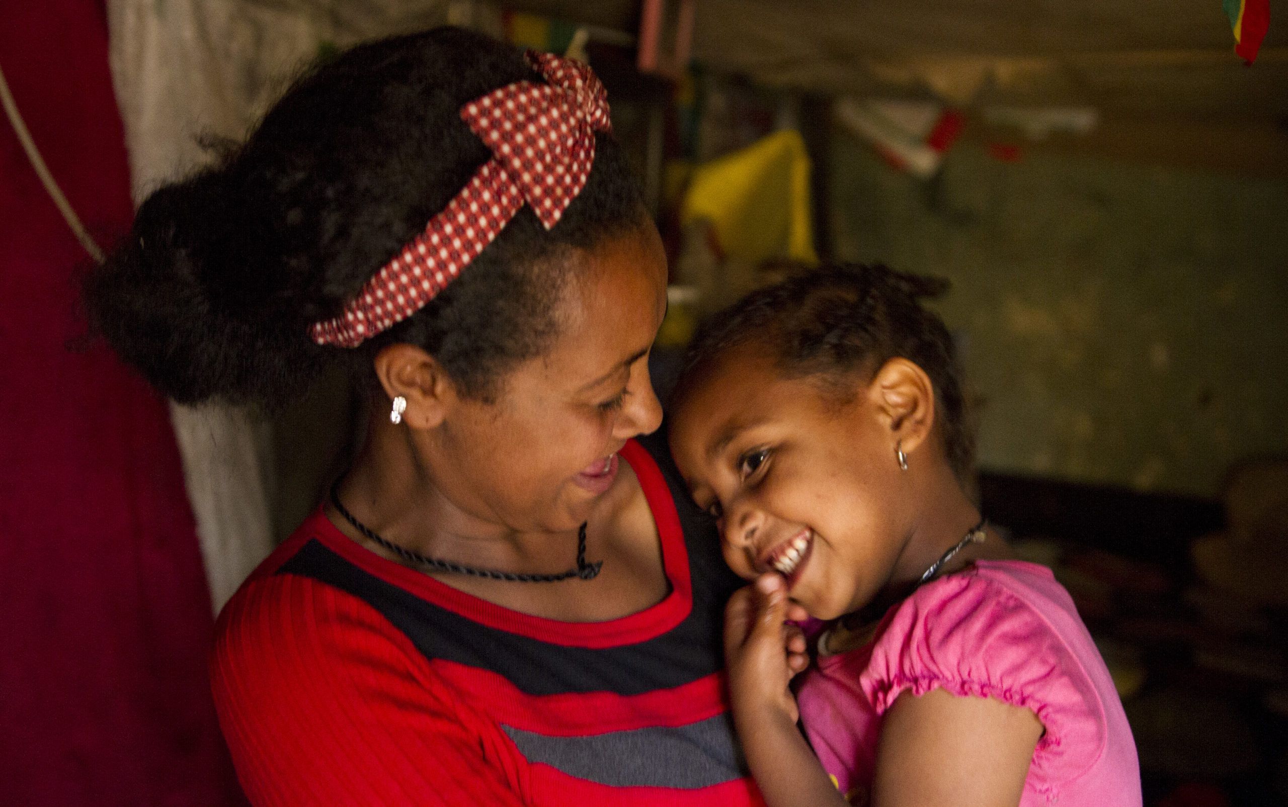 Selamawit, a volunteer at the Drop-In and Rehabilitation Centre of ChildSPACE programme in Addis Ababa, with her daughter Hermela in their home in June 2018, Ethiopia.