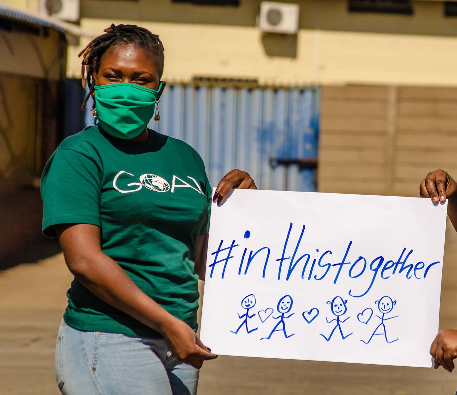 GOAL Zimbabwe staff holds placards as part of their awareness campaign on the rising incidences of Gender-Based Violence during the COVID-19 pandemic. 
