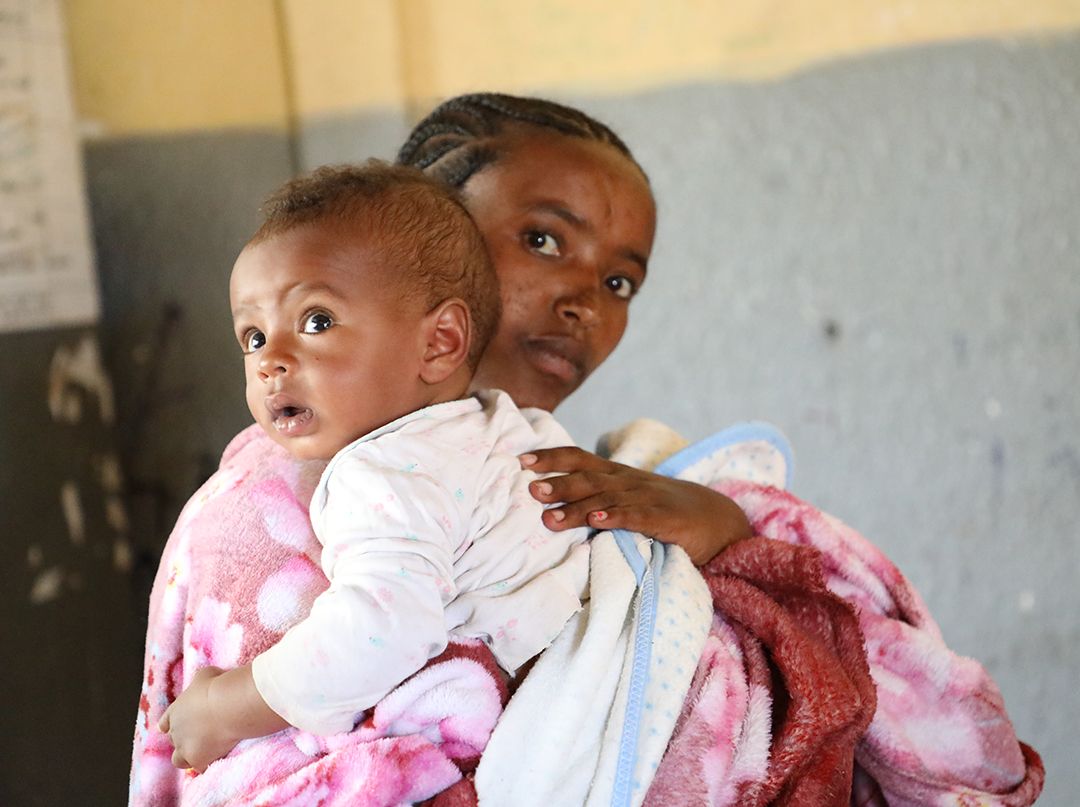 Haregewoyne and her young son Biruk in the internally displaced persons (IDP) camp teams have set up in a local school.