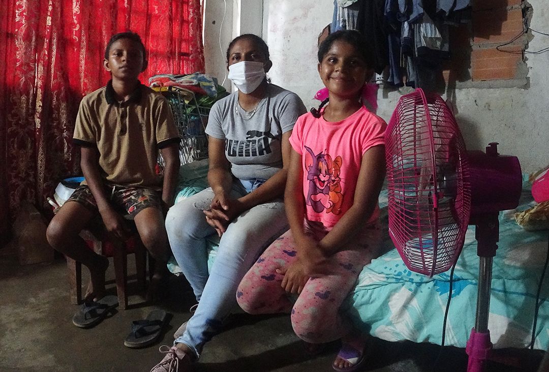 Eva and her family in Colombia. Eva sits with her son Daniel and daughter Elianis in their new home in Colombia