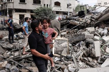 Young girl cries with father among rubble in Gaza Crisis