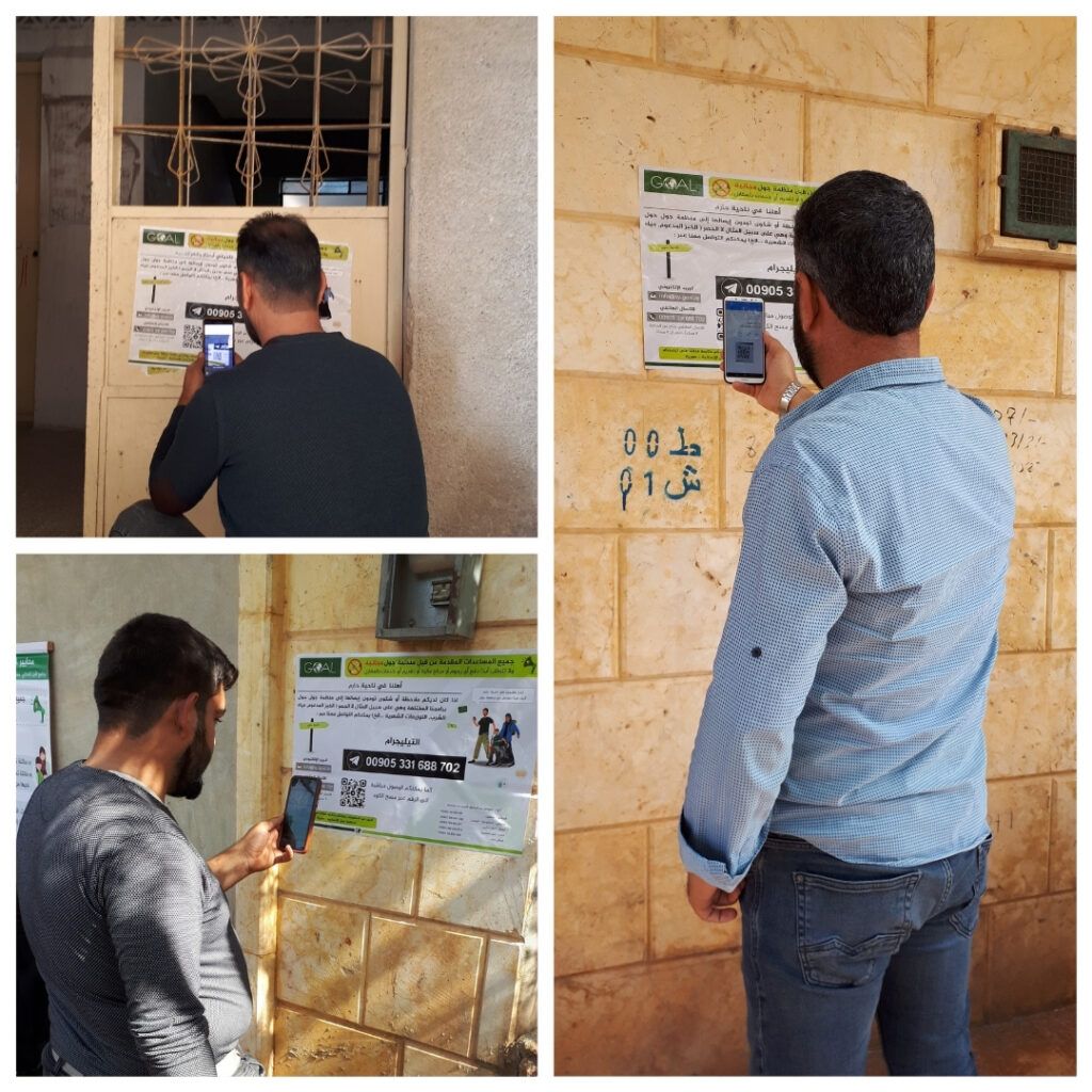 Community member in Syria scanning QR code to reach GOAL CFM