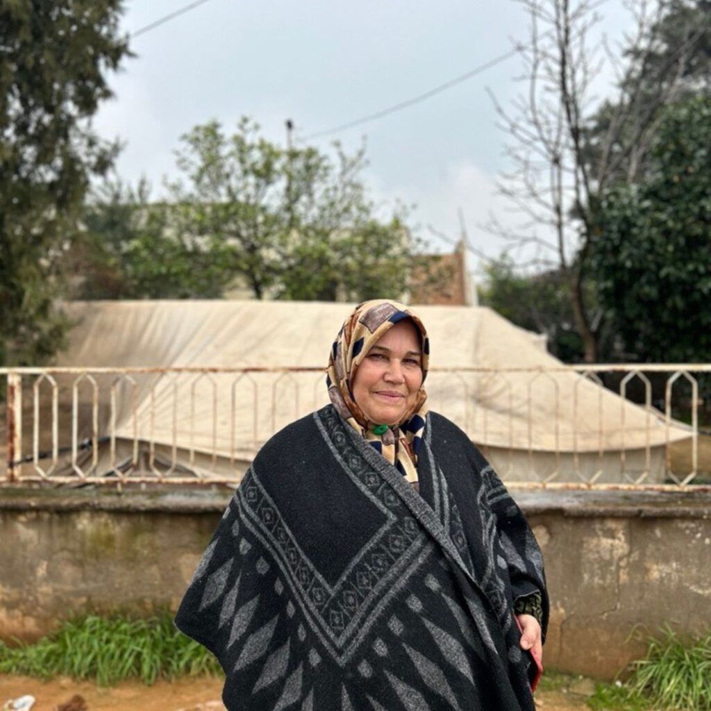 Syrian single mother Fatima stands in displacement camp IN Türkiye 