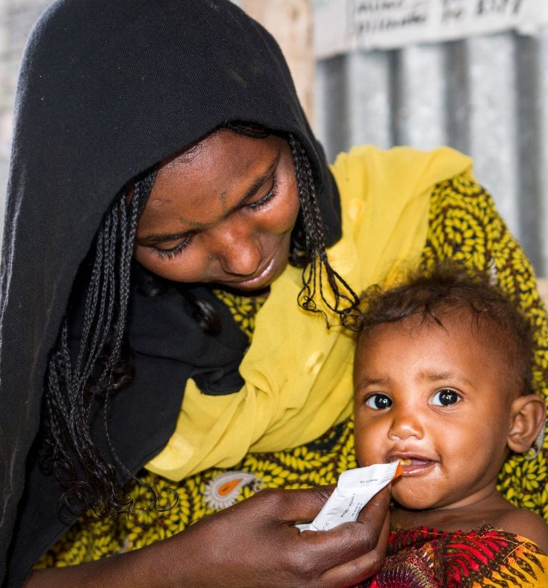 GOAL RG ACQ Campaign_Malnutrition_Mother and Child A mother feeding her infant a highly nutritious food