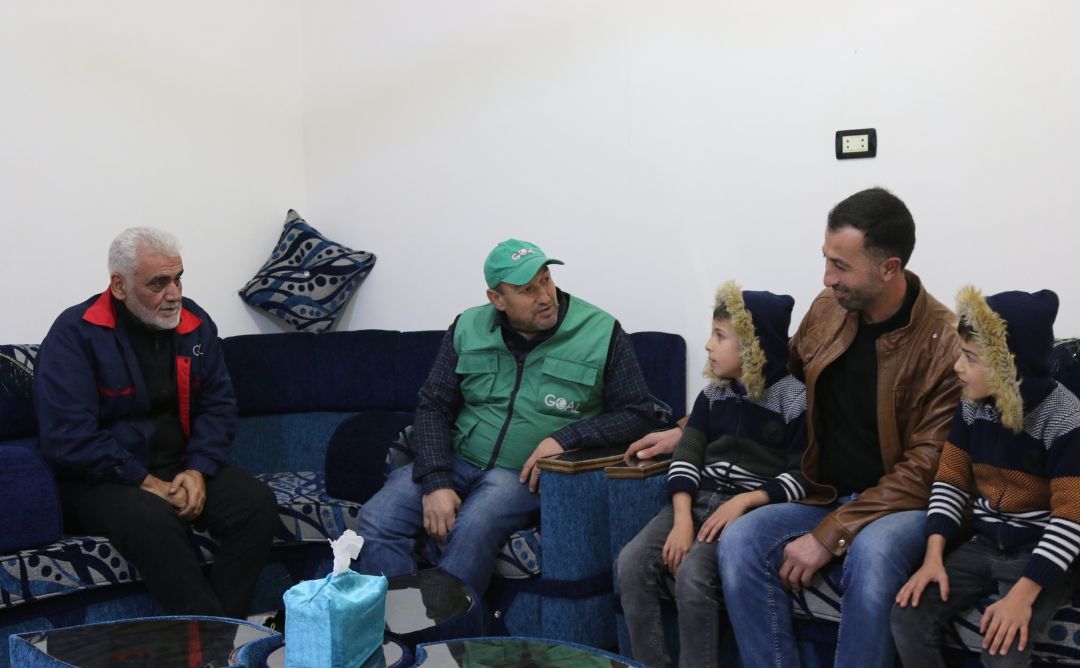 GOAL Syria WASH Engineer speaking with a family in Idleb