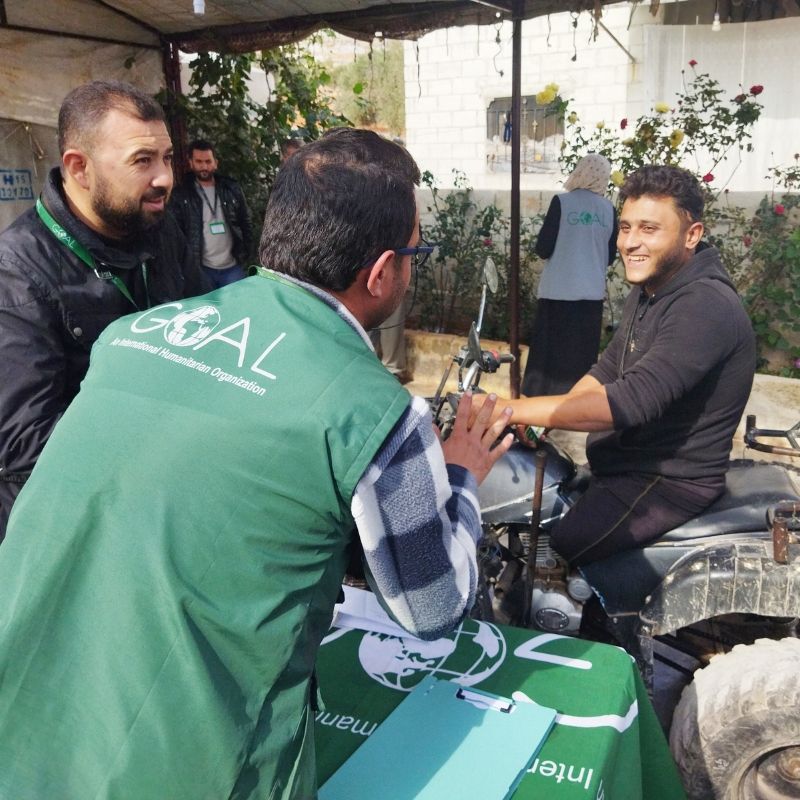 SANAD Cycle 3_LP_GOALie and beneficiary (1) Abu Hilweh at a GOAL aid distribution point in Idleb, Syria.