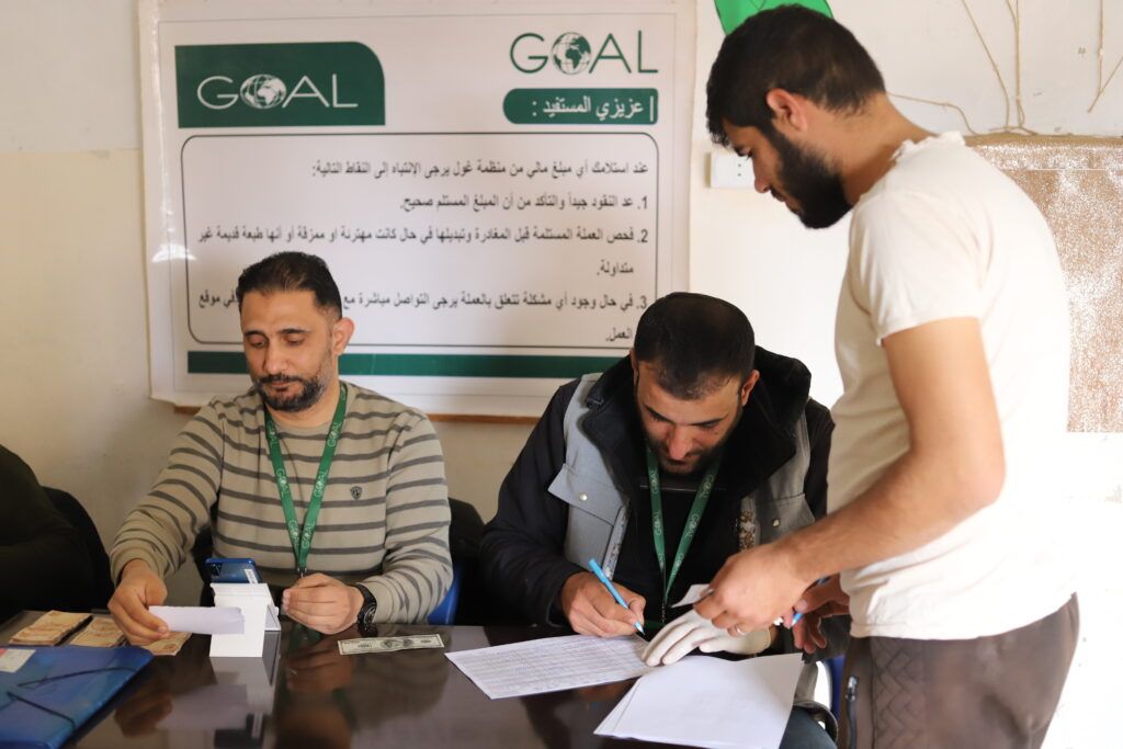 Abdul Al-Hilawi - 28 years old- receives winter MPCA assistance at a distribution point in northwest Hama. © GOAL Syria. Photographs by Abulrahman Kayali.