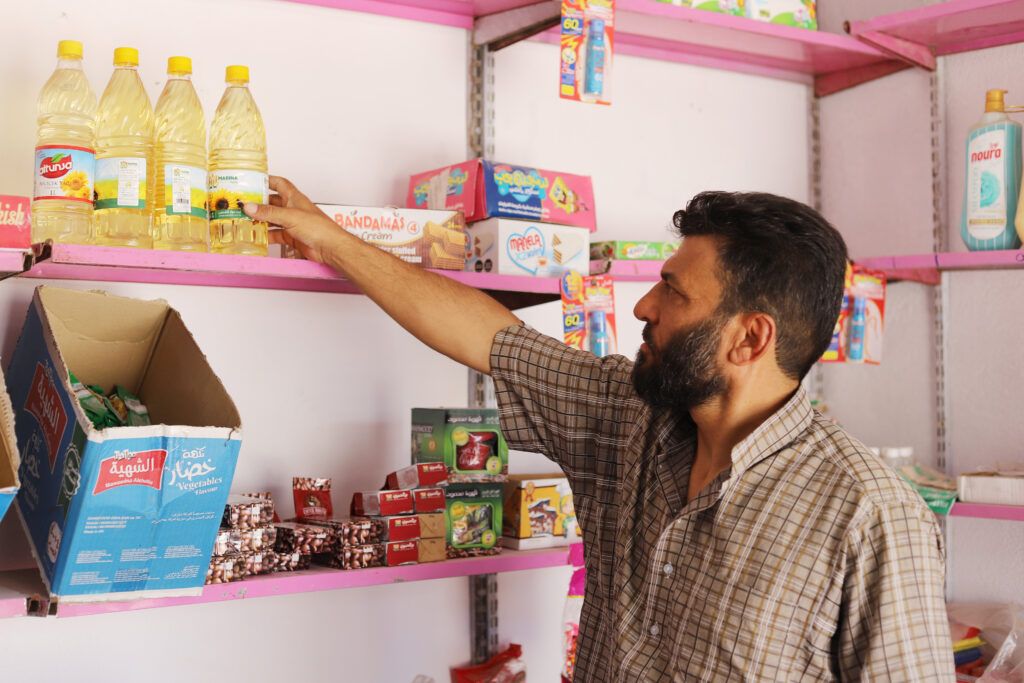 Ahmed Al-Ibrahim, 45 years old, is shopping for essential supplies in Haysh village after receiving GOAL's cash assistance.