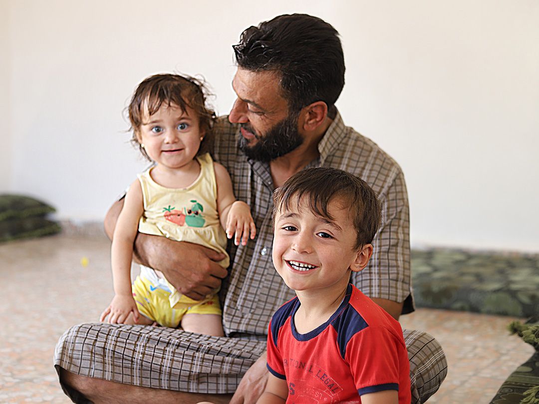 Ahmed plays with his one-year-old daughter Fatima and 4-year-old son Omar
